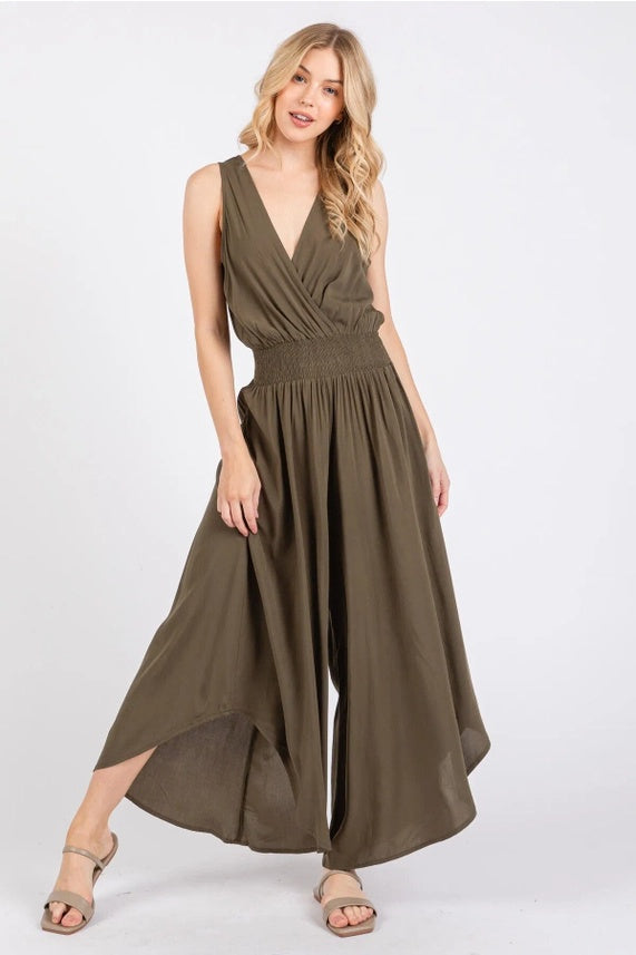 Woman wearing a brown Smock Waist Jumpsuit on a white background